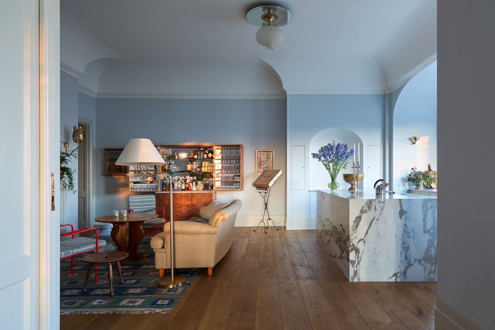Image may contain Flooring Floor Wood Living Room Room Indoors Hardwood Furniture Couch Interior Design and Table
