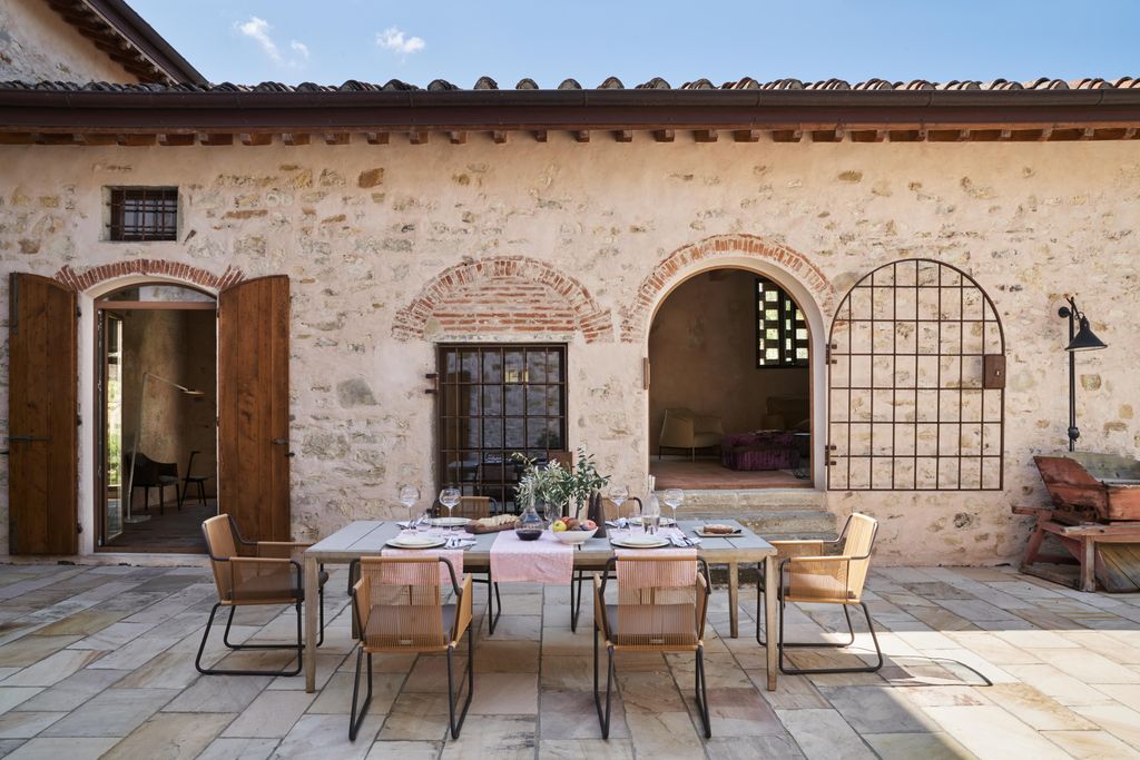 Image may contain Furniture Chair Patio Housing Villa House Building Table and Dining Table