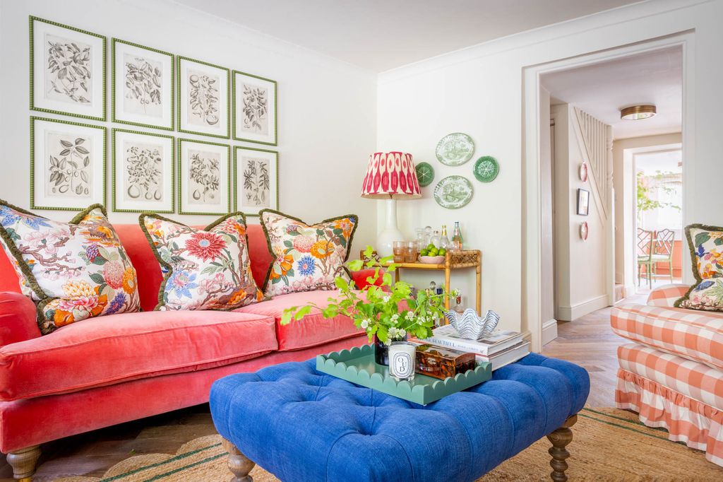 The bright pink sofa is covered with cushions in GP J Baker 'Magnolia' fabric whose colours are then used throughout...