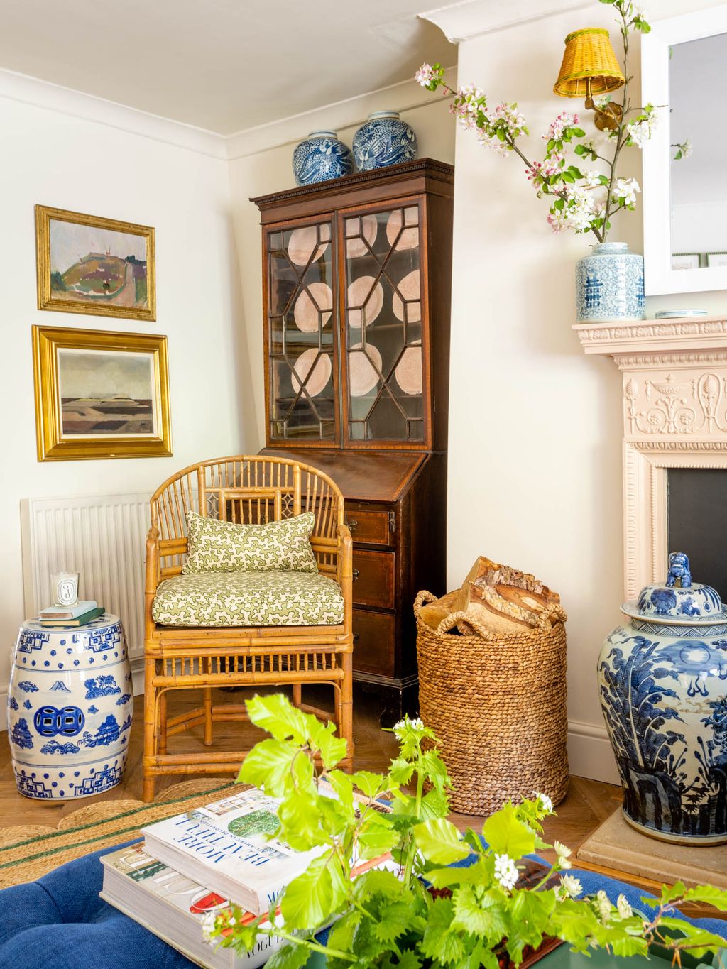An antique dresser and blue and white ceramics populate one corner of the room.
