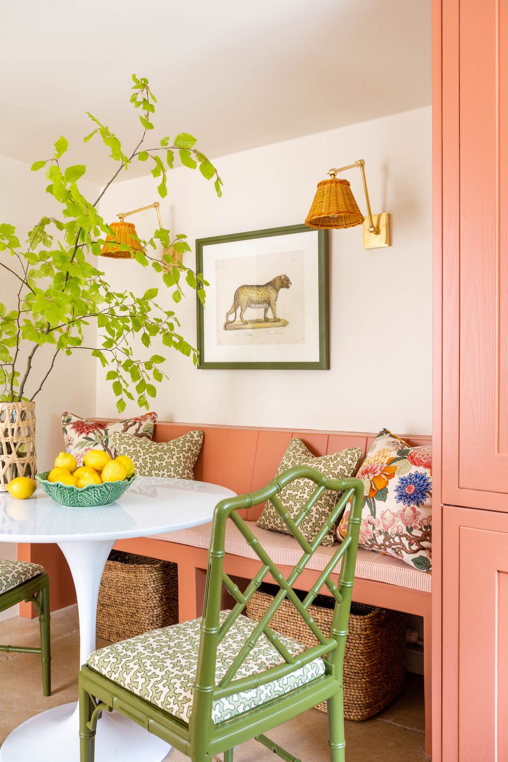 A builtin banquette also in ‘Red Earth makes the best use of the space in the kitchen and features Vaughan wall lights...