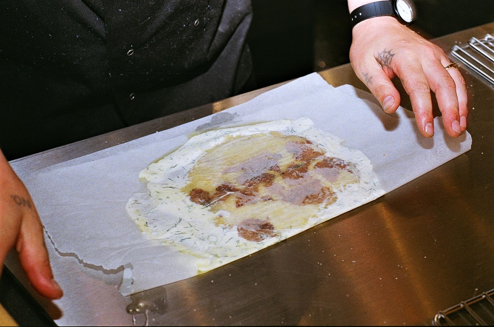 Image may contain Human Person Wristwatch Food Wood and Bread