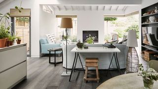 Image may contain Furniture Flooring Indoors Room Interior Design Living Room Wood Table Hardwood and Floor