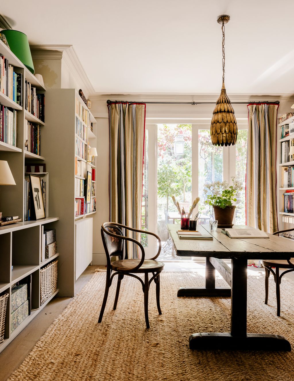 Over the 18thcentury oak monastery table hangs a vintage Italian gilded bronze light dating to circa 1970 from Howe. The...