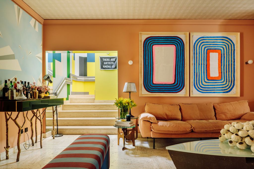 Image may contain Living Room Room Indoors Furniture Couch Table Flooring Interior Design and Lobby