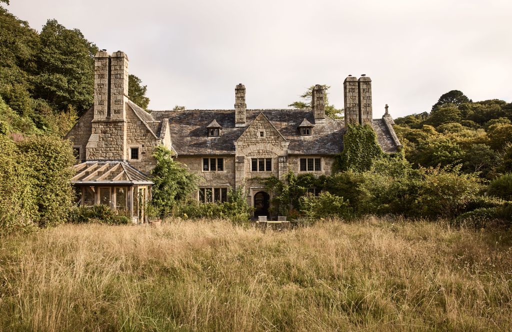 The lawn was allowed to grow and was seeded with wild meadow flowers softening the appearance of the thick granite...