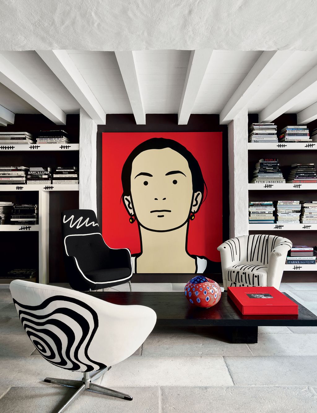 Image may contain Furniture Interior Design Indoors Chair Shelf Living Room Room Bookcase Table and Cushion