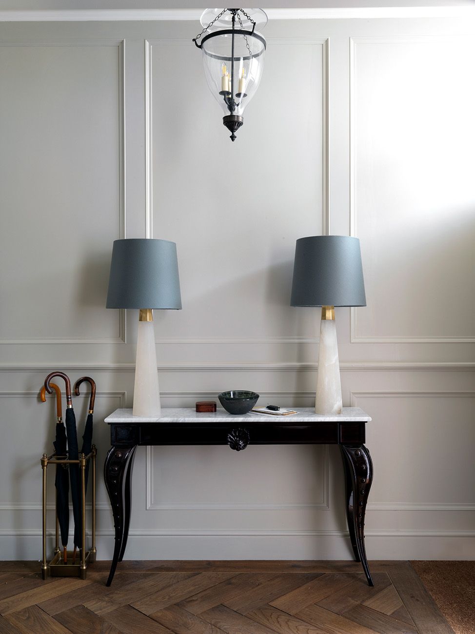 In the hallway of this multifaceted Chelsea townhouse the lamps are Olsen Table Lamps from Visual Comfort. The...