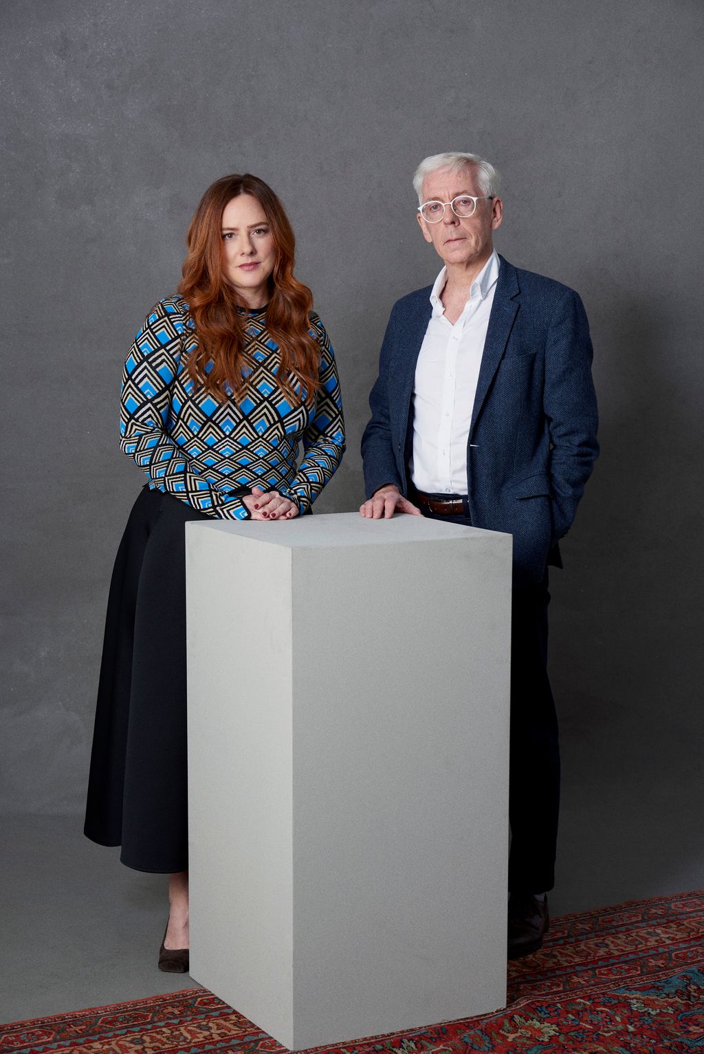 Image may contain Human Person Clothing Apparel Sleeve Long Sleeve Furniture Suit Coat and Overcoat