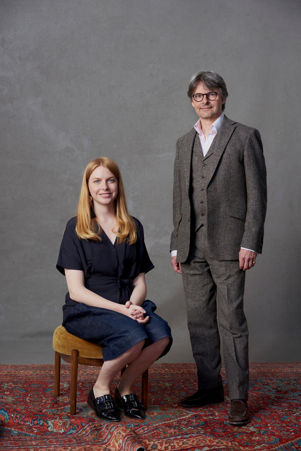 Image may contain Clothing Apparel Human Person Suit Coat Overcoat Footwear and Shoe