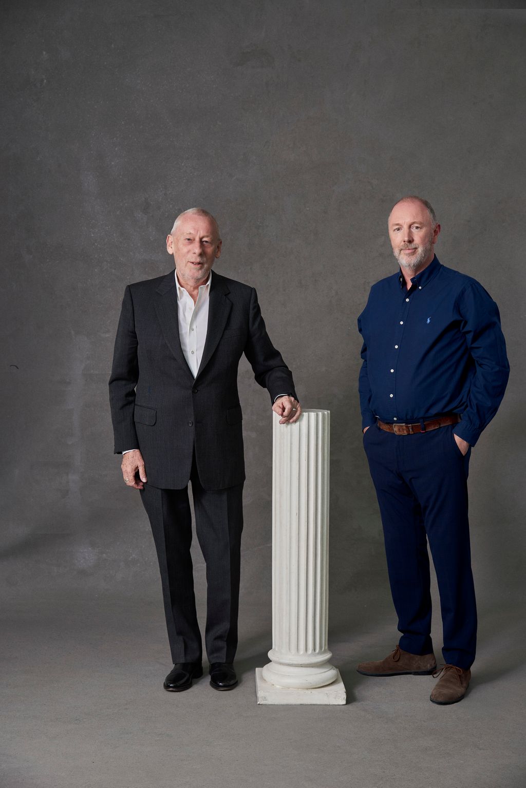 Image may contain Clothing Apparel Human Person Footwear Shoe Pants Sleeve Suit Coat Overcoat and Furniture