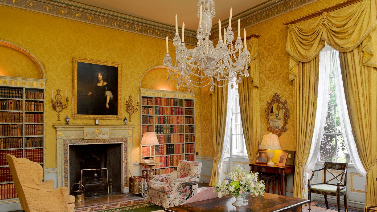 Image may contain Living Room Room Indoors Furniture Fireplace Interior Design Lamp Chandelier Table and Chair