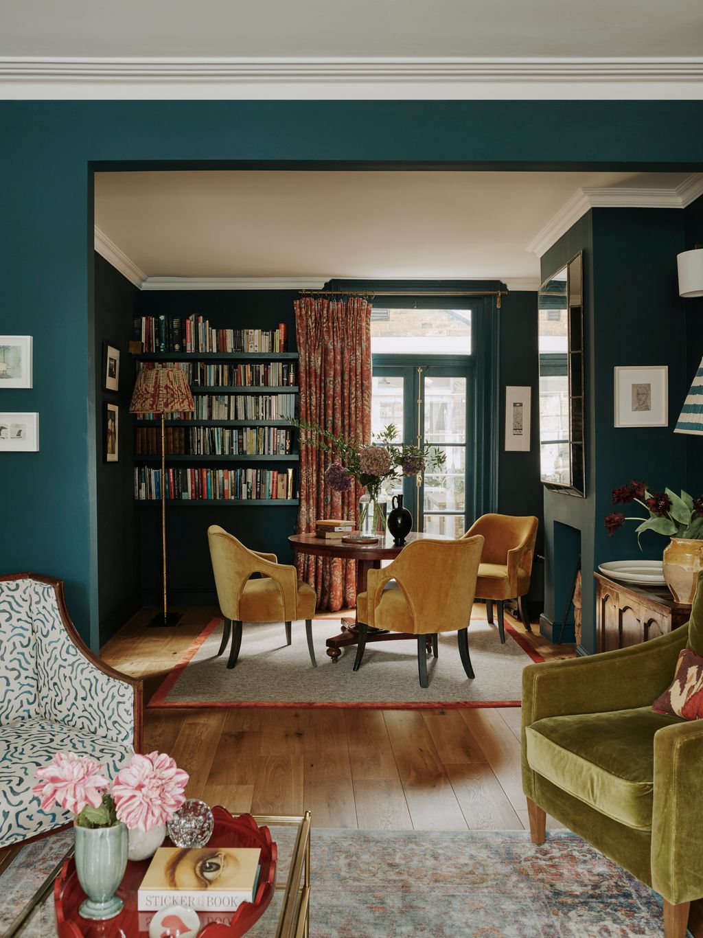 Beyond the living room is a games area. The round table is from eBay and the armchairs are from Love Your Home. The...