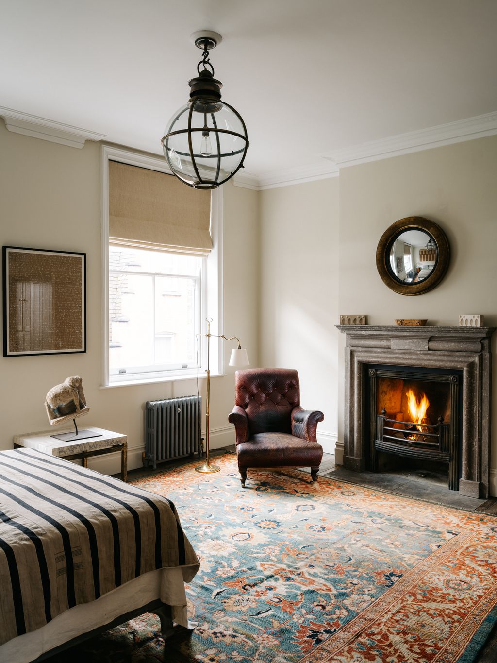 A ‘Morton globe light hangs overhead the carpet is antique.
