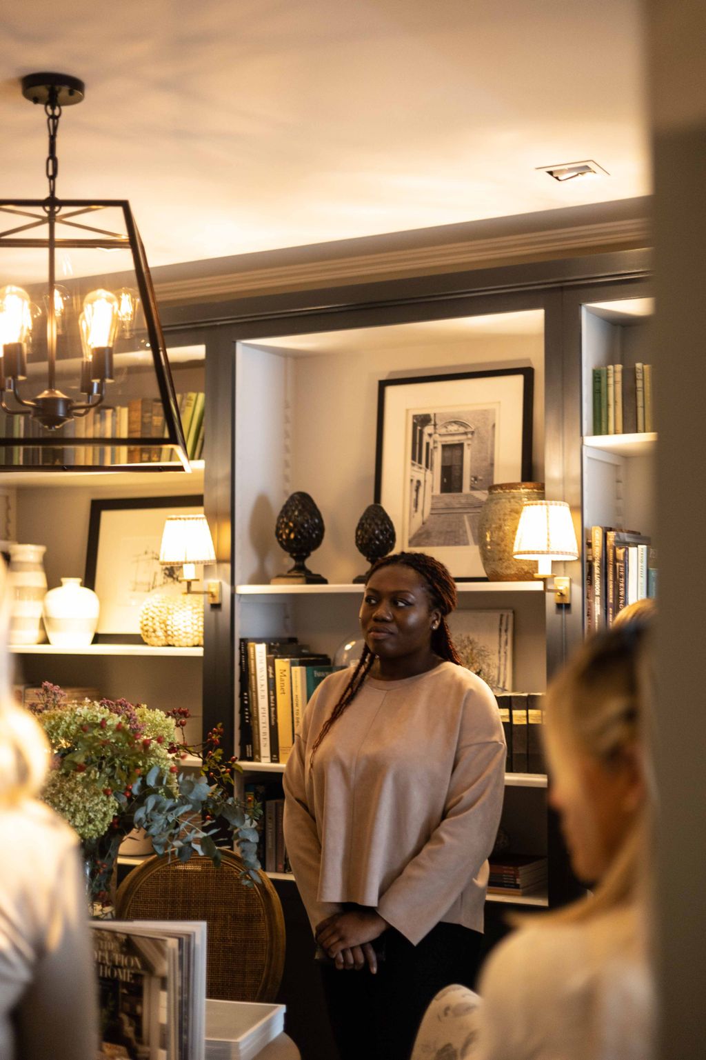 Image may contain Human Person Lighting Interior Design Indoors Shelf Light Fixture and Lamp