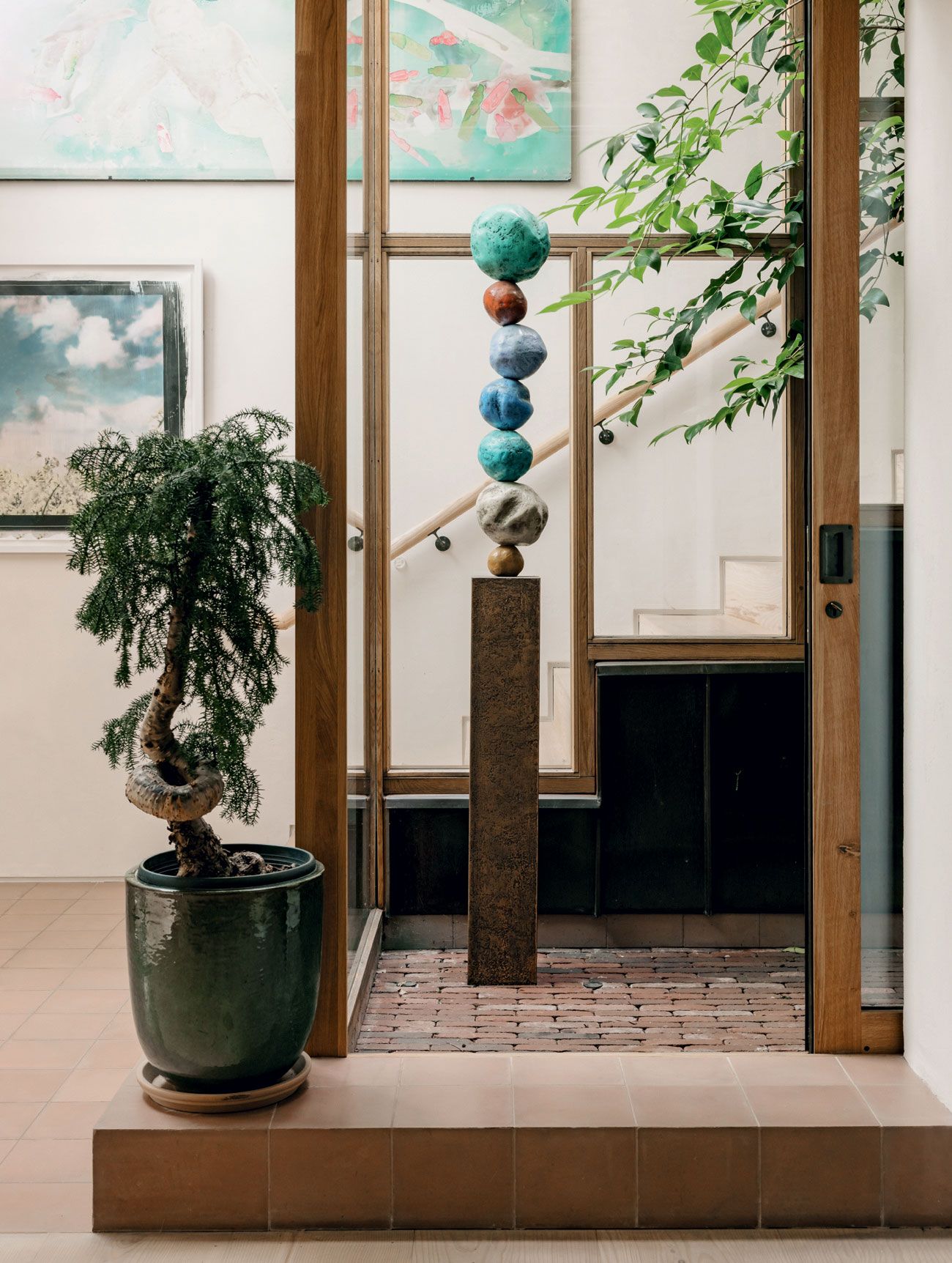 Annie Morriss Bronze Stack 7 Viridian Green sculpture is framed by the Japanese influenced timberframed glass panels...