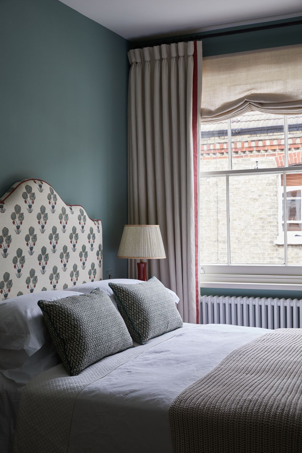 In this bedroom of a house in Hove by Isabella Worsley walls painted in Edward Bulmer's ‘Aquatic provide a moody...