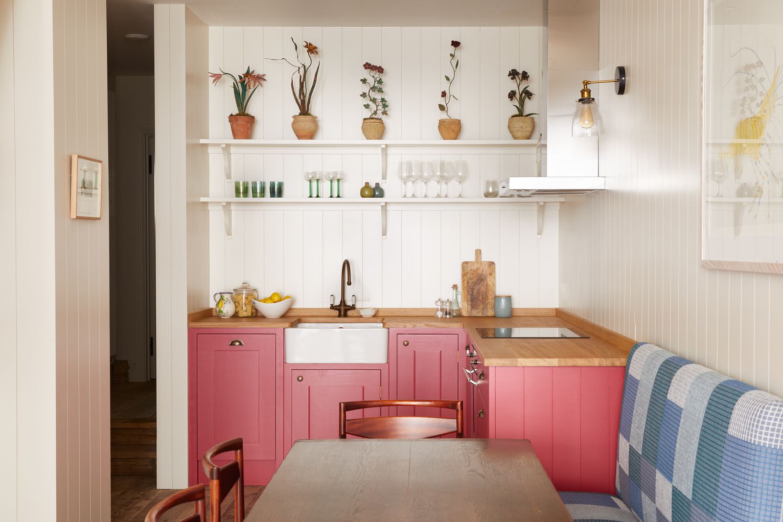 The compact British Standard kitchen is painted in Paint and Paper Library's ‘Elizabethan Red.