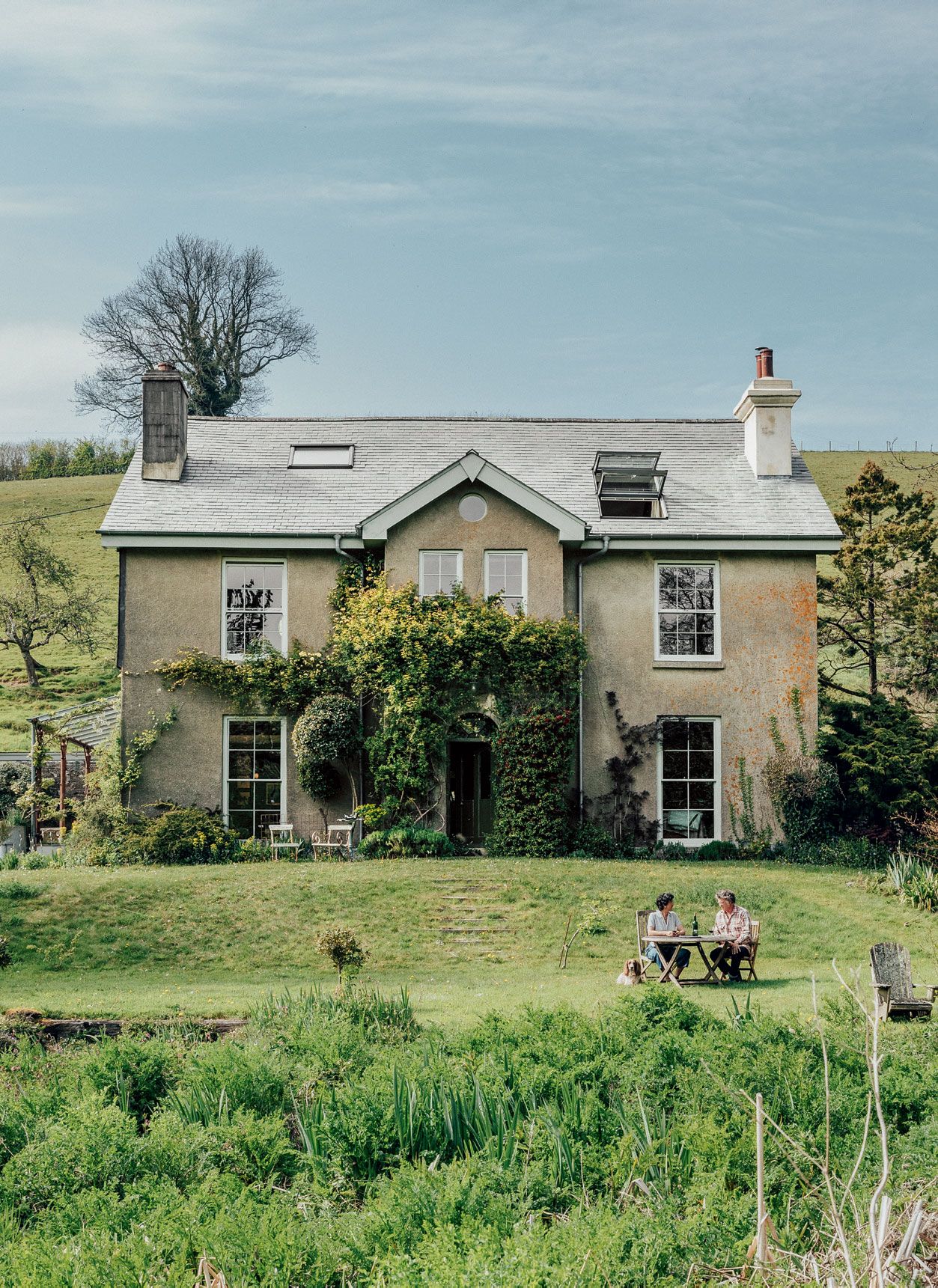 Geetie and Guy in their garden at Baddaford Farmhouse.