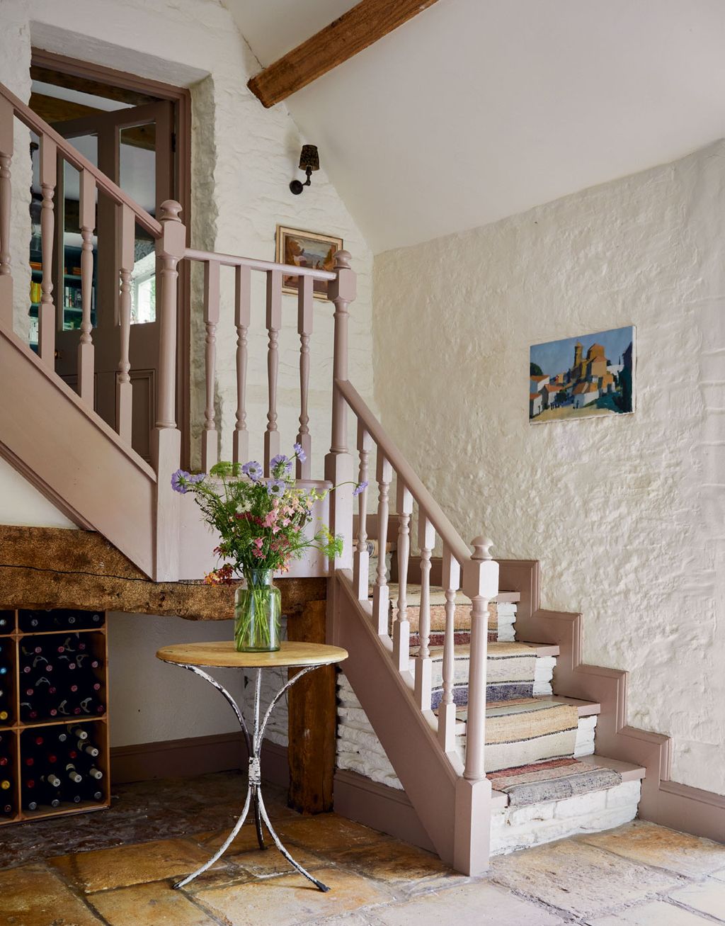 The staircase in Farrow Balls ‘Dead Salmon is softened by a Swedish flatweave runner.
