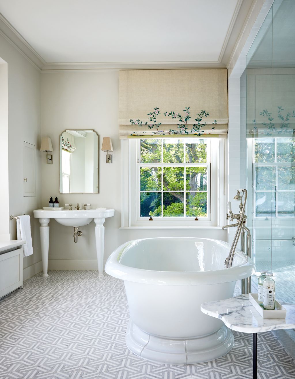 A rolltop bath and Lefroy Brooks ‘La Chapelle console basin are set off by Studio Express ‘Wicker Mosaic floor tiles...
