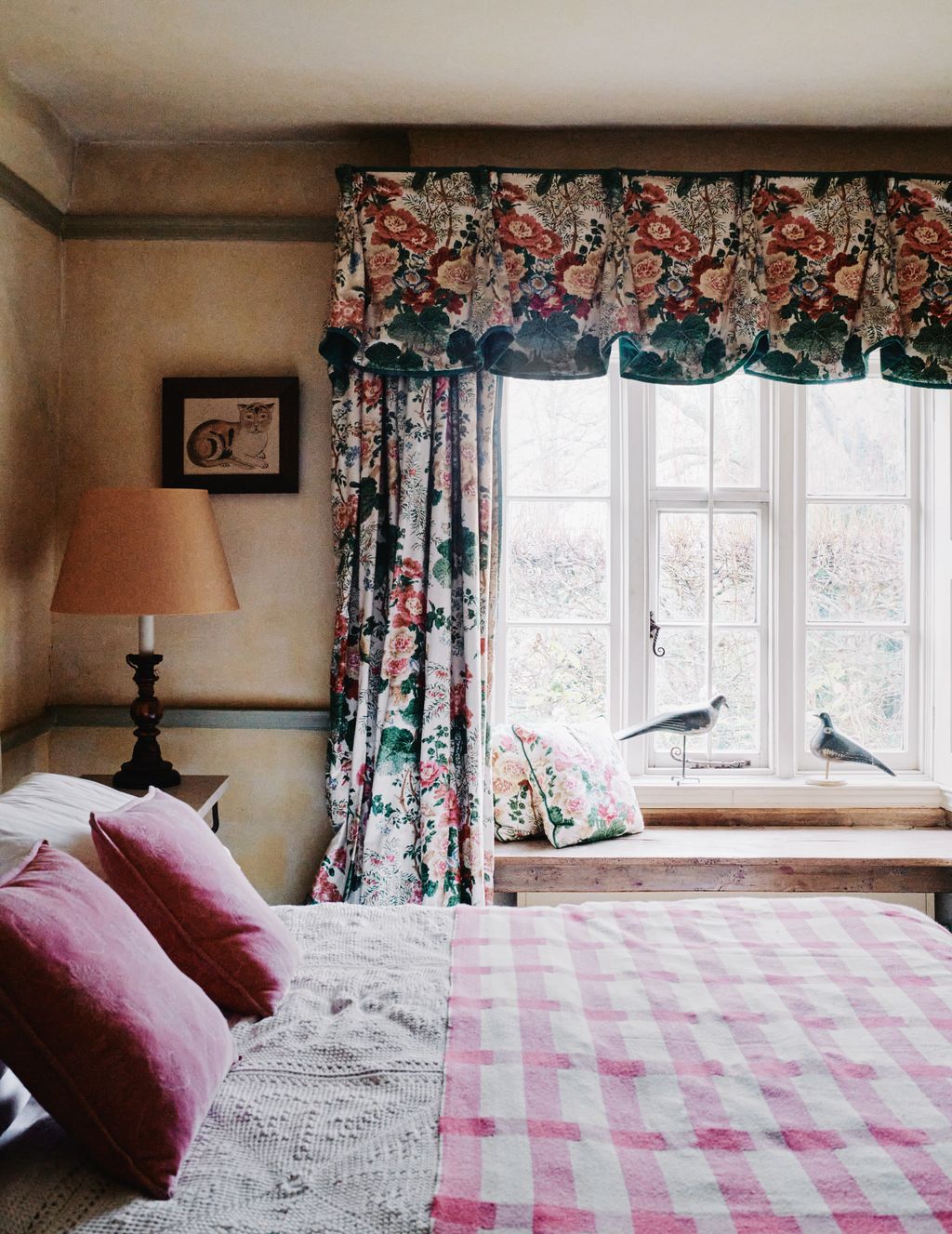 Chintz curtains frame wooden decoy pigeons c1900 sourced by Robert as was the 19thcentury Alsatian bedcover.