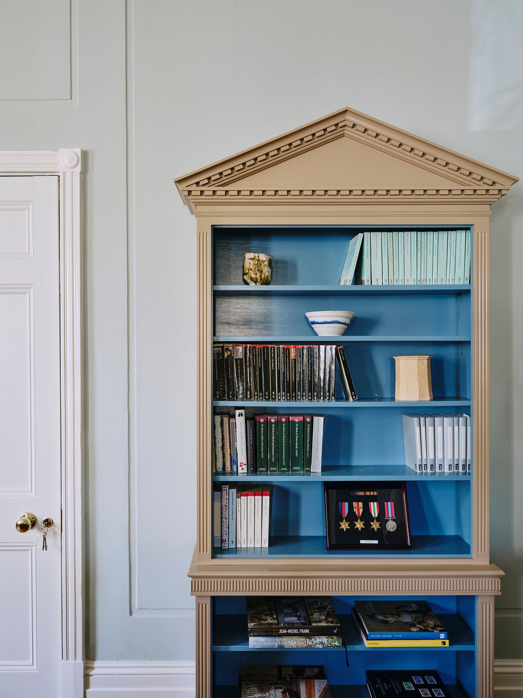 Designer Carlos Garcia likes to use these bespoke pedimented bookcases in his projects  this one comes from a north...