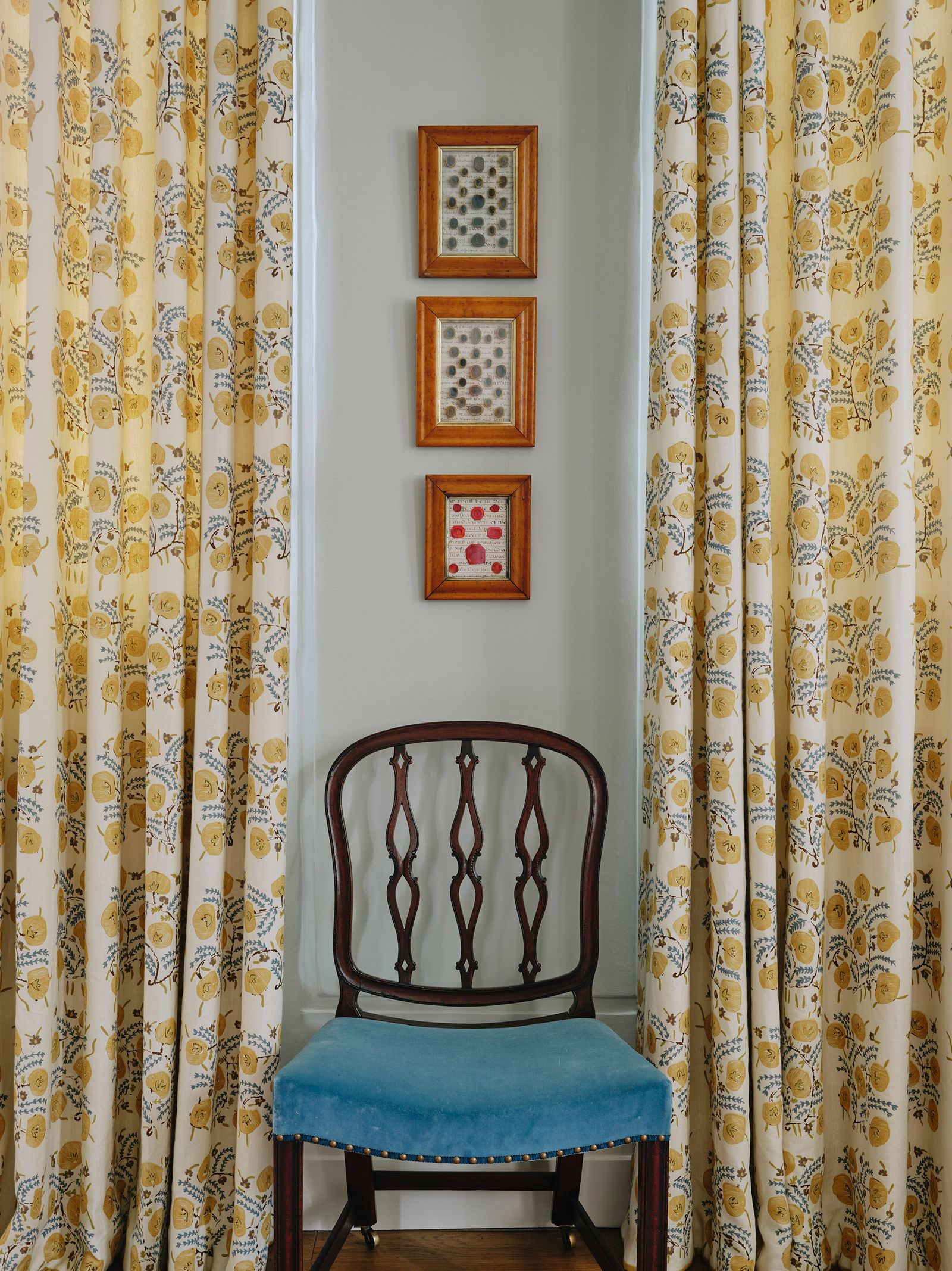 The curtains are in Penny Morrison's ‘Pasha in Adam linen. A chair from Sibyl Colefax amp John Fowler stands between.