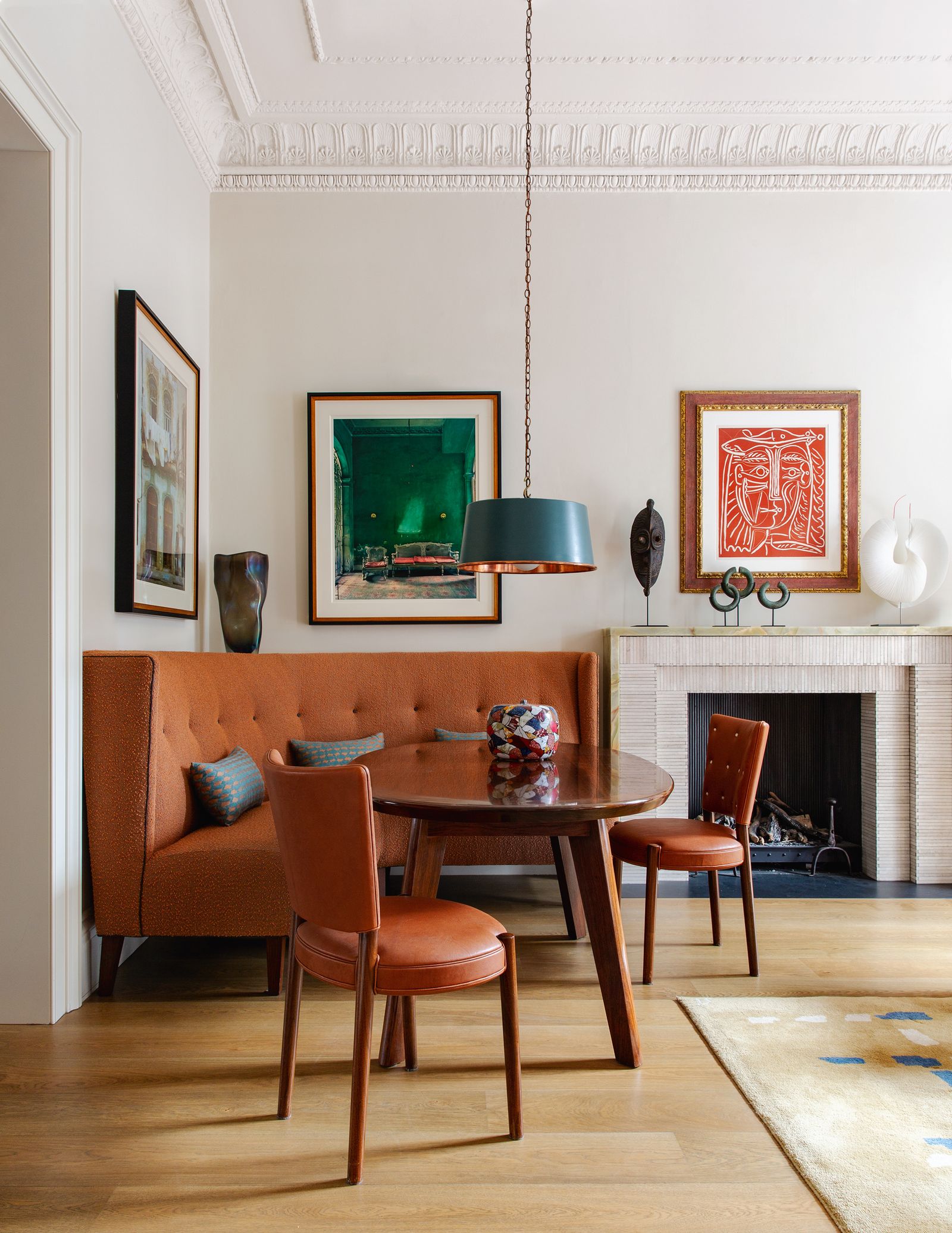 The walnut table the corner banquette and a pair of chairs based on a Scandinavian design  all custom made  create an...