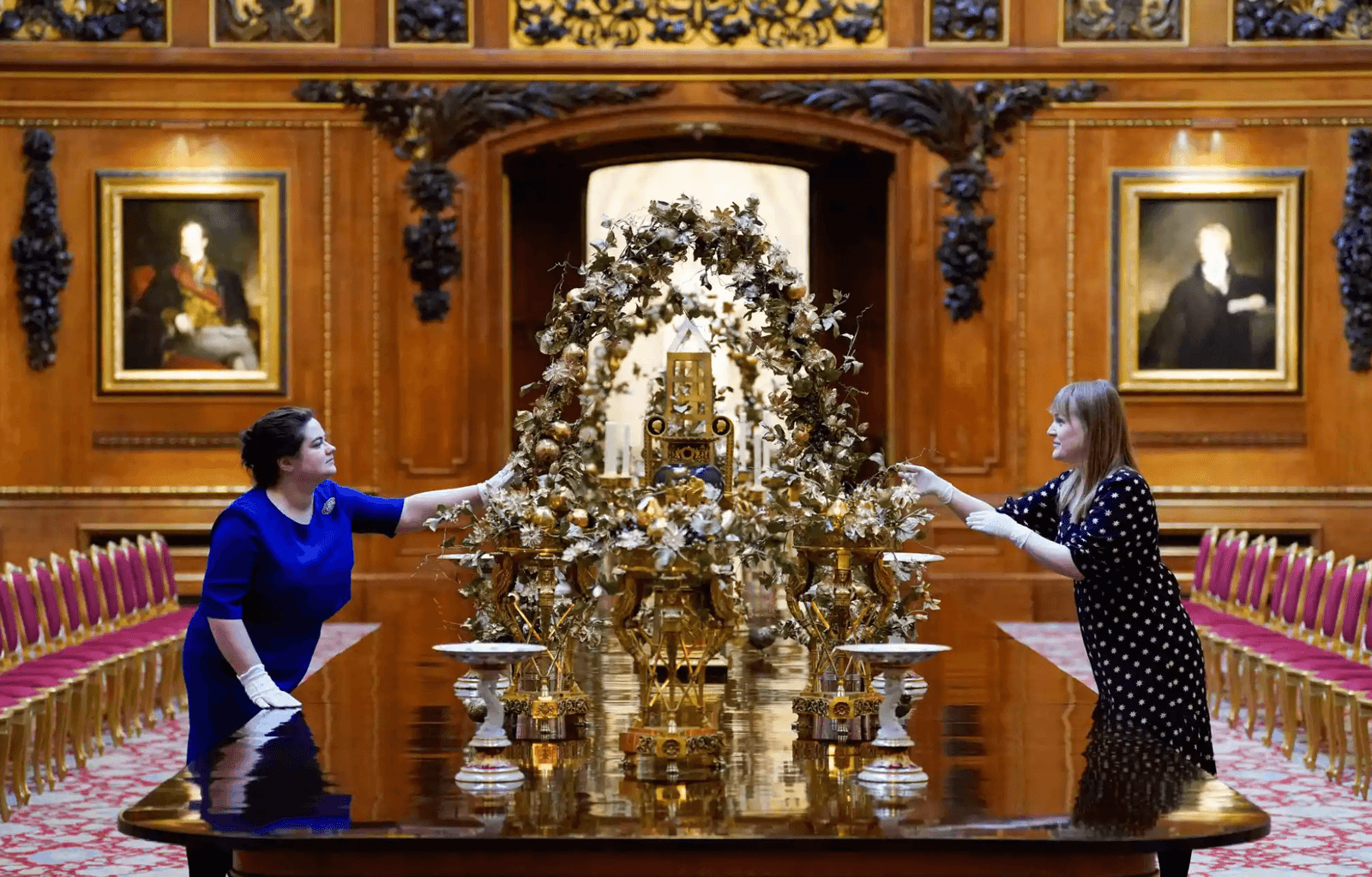A banquet table in the Waterloo Chamber whose centrepiece features a festive array of fruits and foliage.