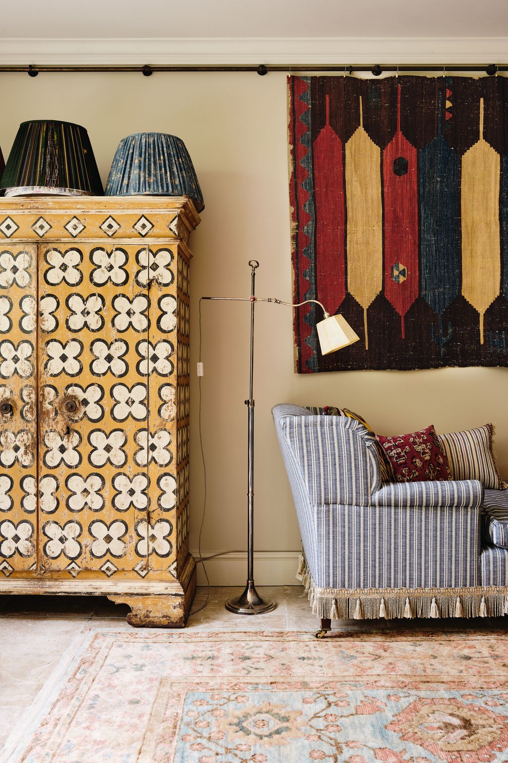 In the Pimlico showroom an 18thcentury north Italian painted armoire is displayed beside a daybed covered in ‘Larsson...