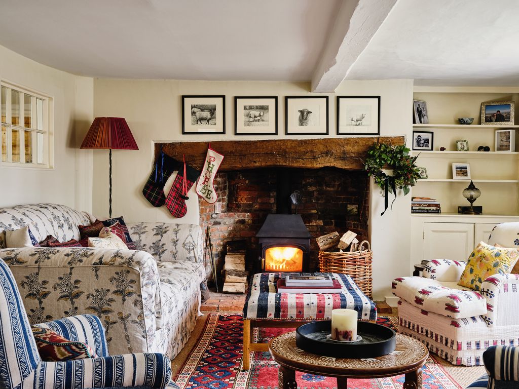 Stockings hang above the charming original fireplace in the sitting room.