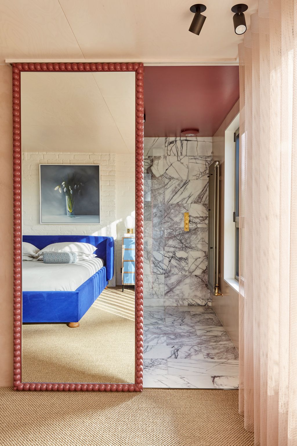 Studio K Space has installed a custom mirrorfronted sliding door in this attic bedroom behind which is an en suite...