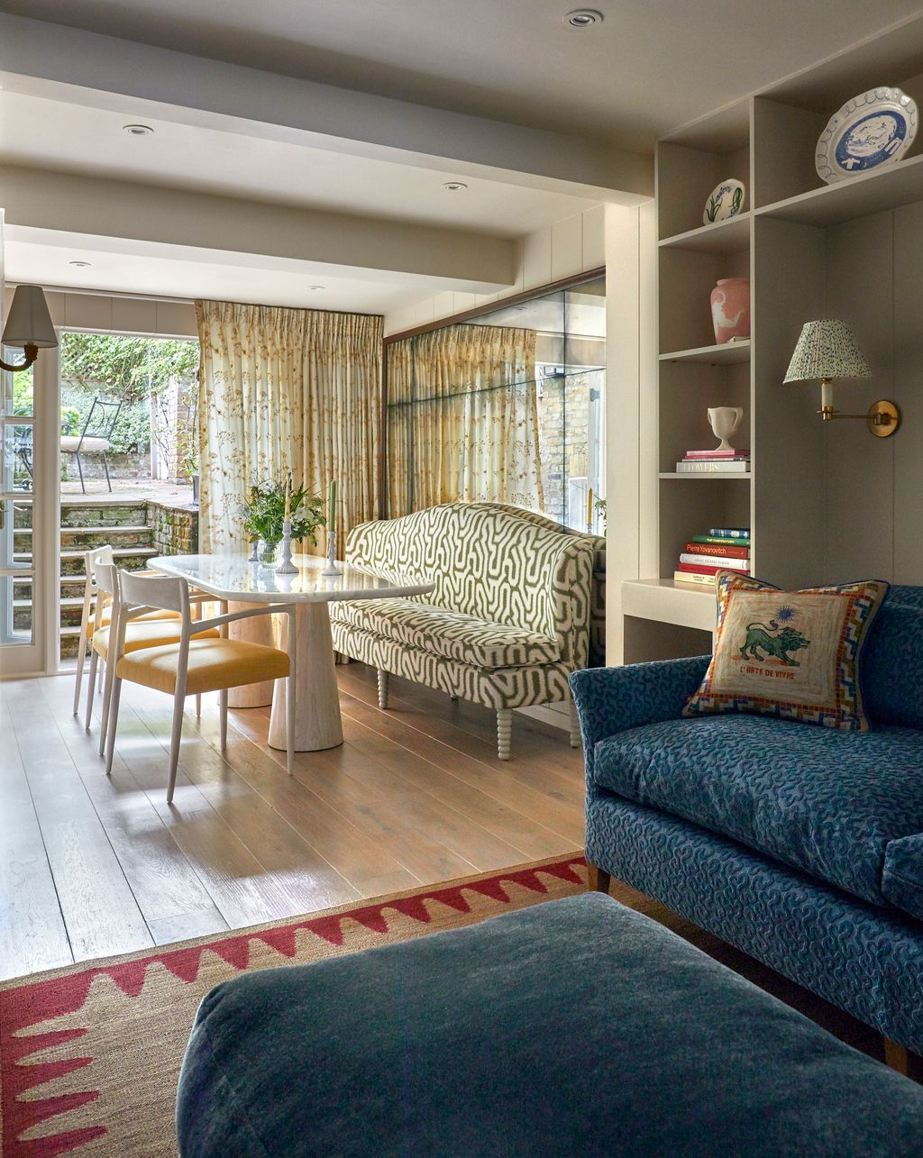 In the lower ground floor a TV snug leads onto the dining room. A large bespoke mirror helps to bounce light around...