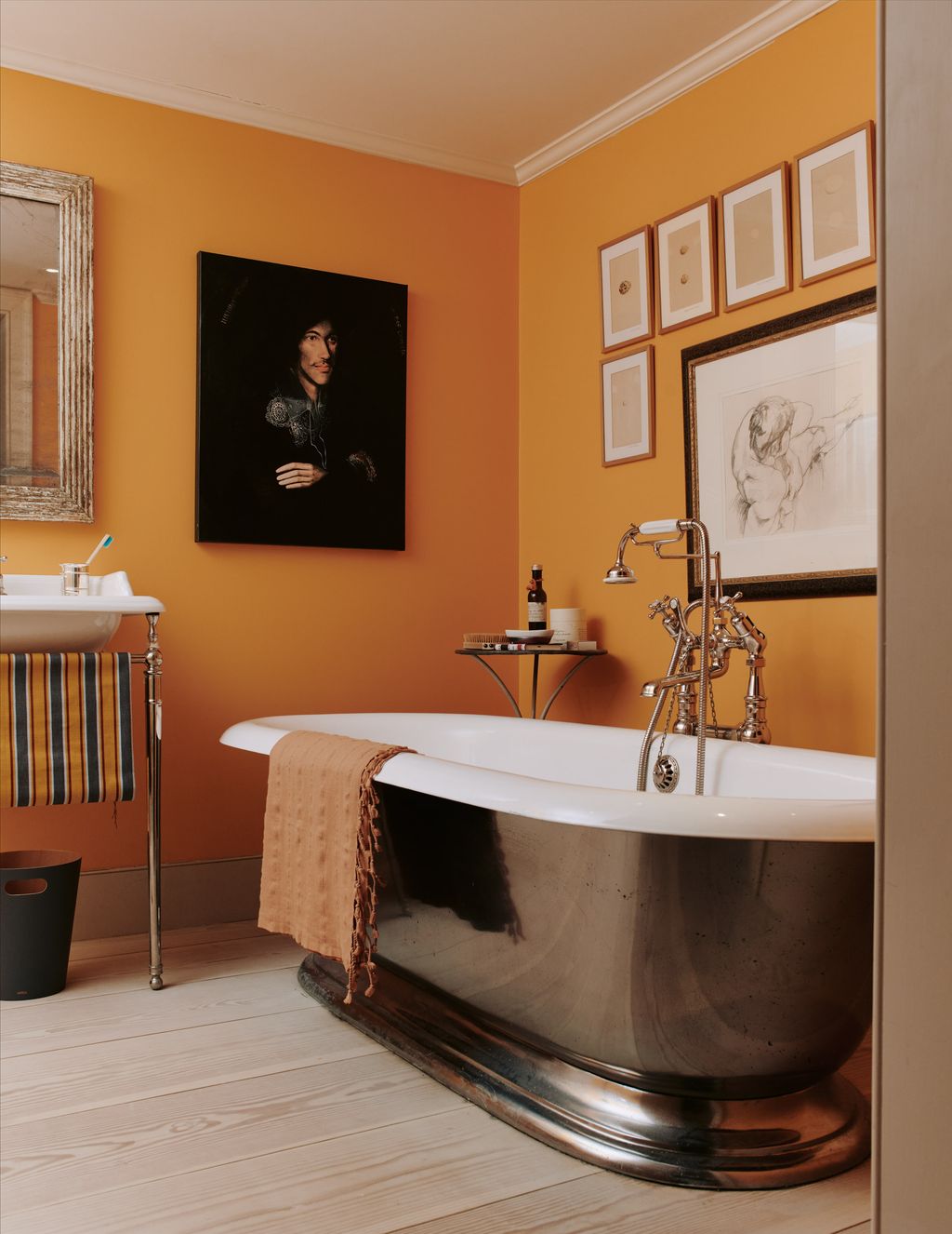 The bathroom features an archive orange colour from Craig Rose on the walls.