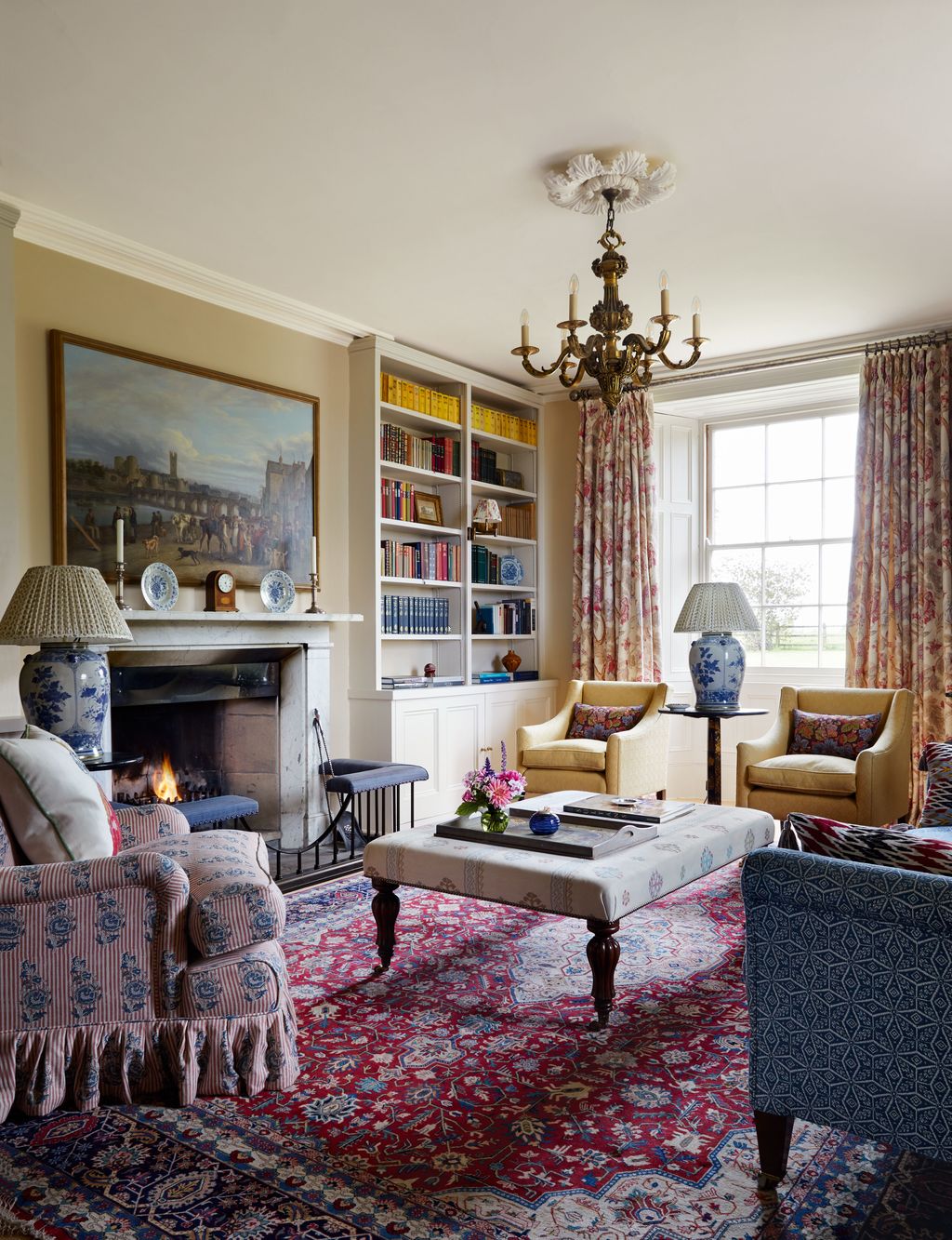 The custom magnolia paint from Edward Bulmer on the walls sets off an elegant mix of fabrics in the living room of this...