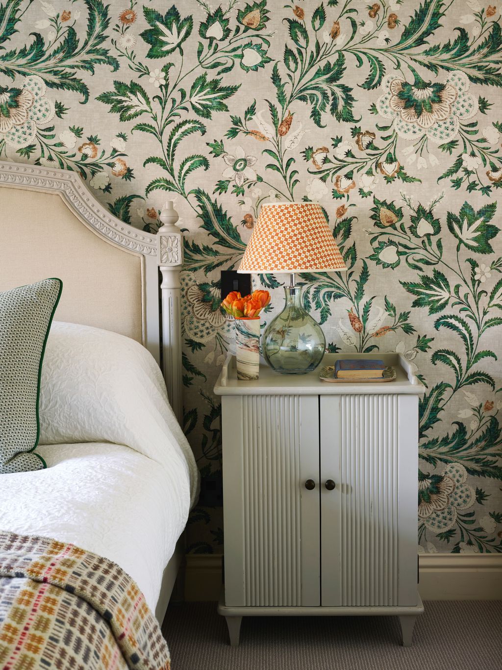 A Rosi de Ruig lampshade and wool throw from FelinFach pick up on Lewis  Woods ‘Coromandel wallpaper in malachite.