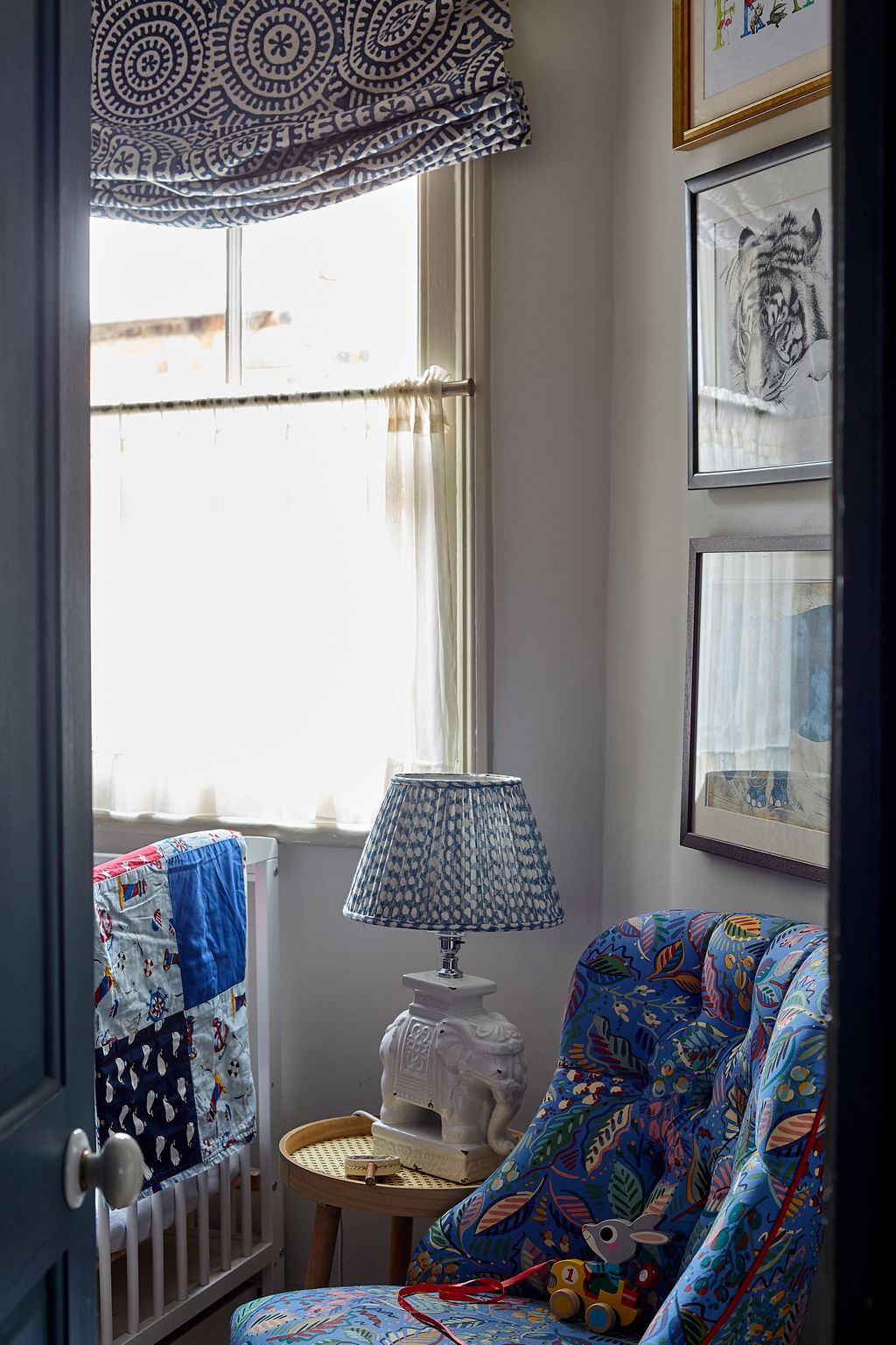 In the nursery a vintage chair has been reupholstered in Leaf Dance by Collier  Campbell. The lamp base is from John...