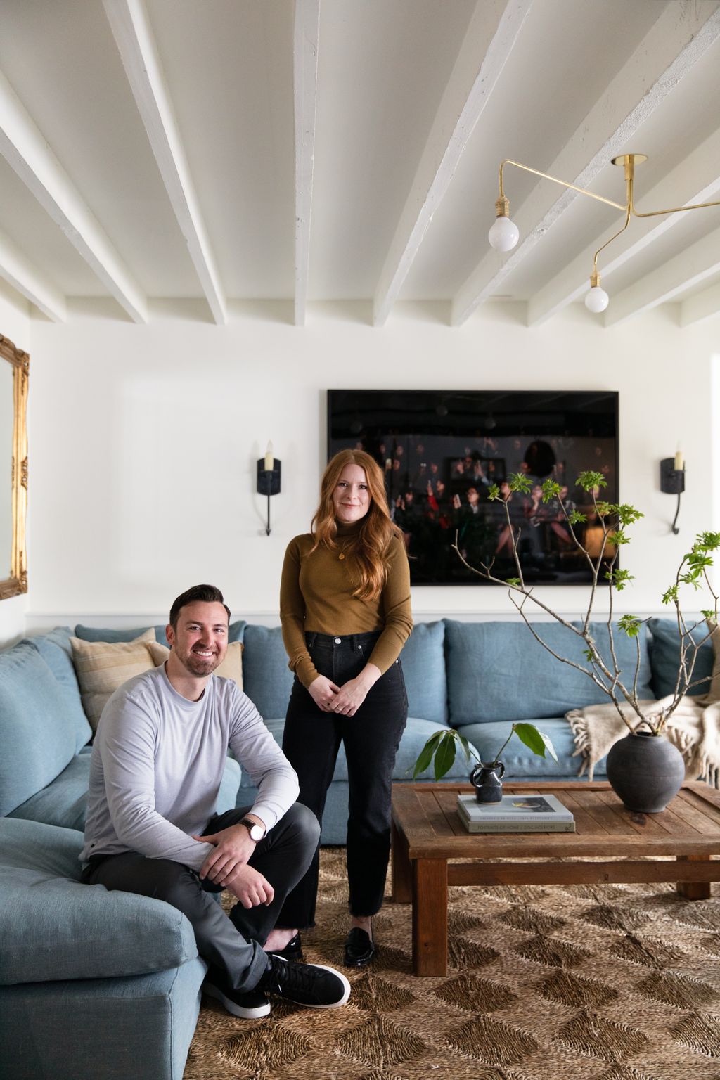 Hana and architectfriend Jack Hotho pose together in the basement's living area.