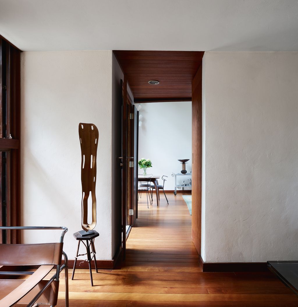 Displayed on a folkart stool the moulded plywood leg splint is Charles and Ray Eames notable Second World War design.