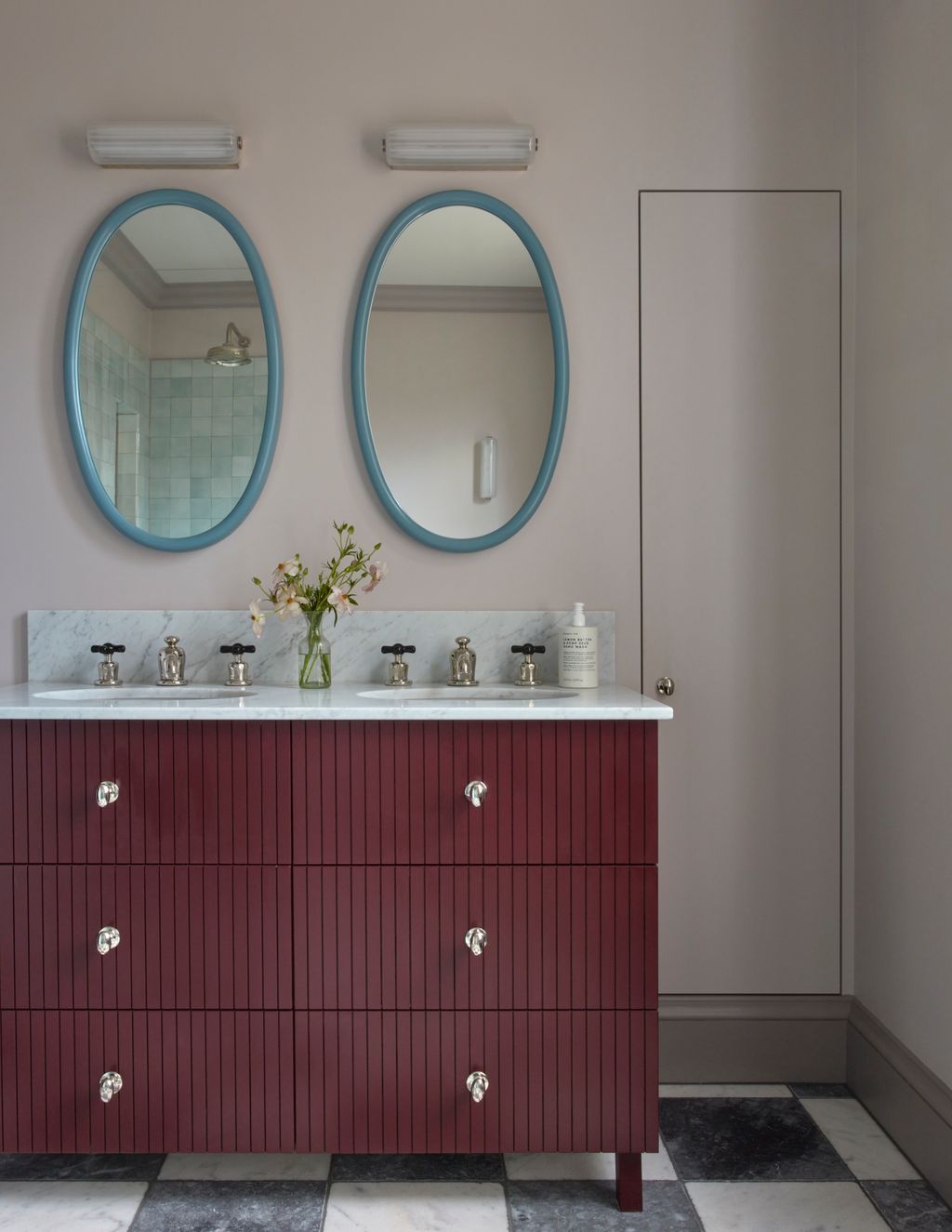 The main bathroom features a bespoke vanity painted in Pure Original's Old Wine. Mirrors from Reid Wright have been...