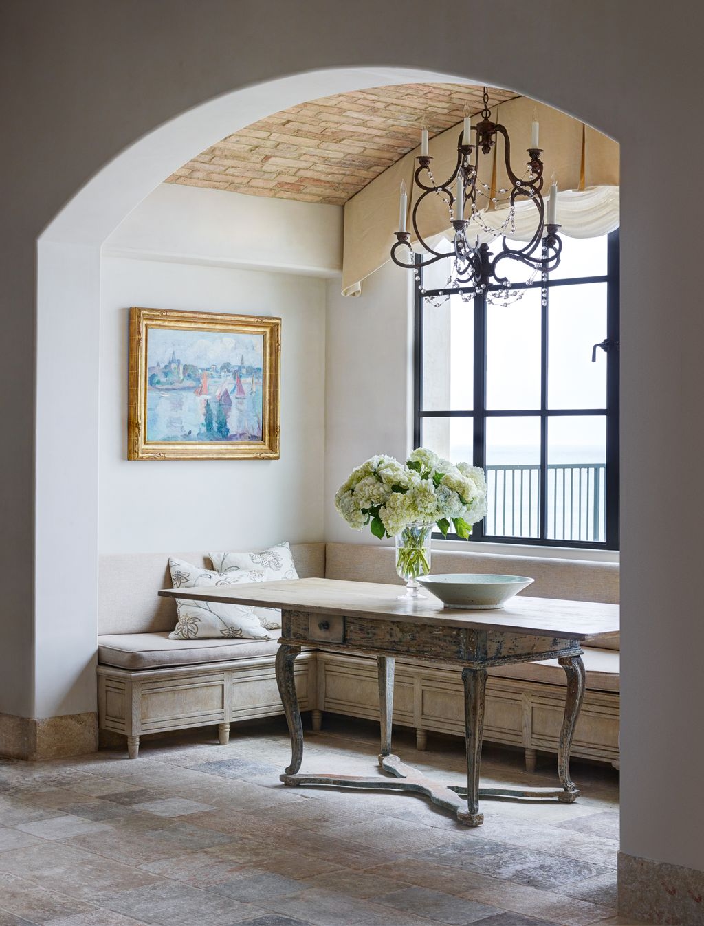 Reclaimed bricks on the vaulted ceiling of this room decorated by ODG Interiors introduces texture to an otherwise...