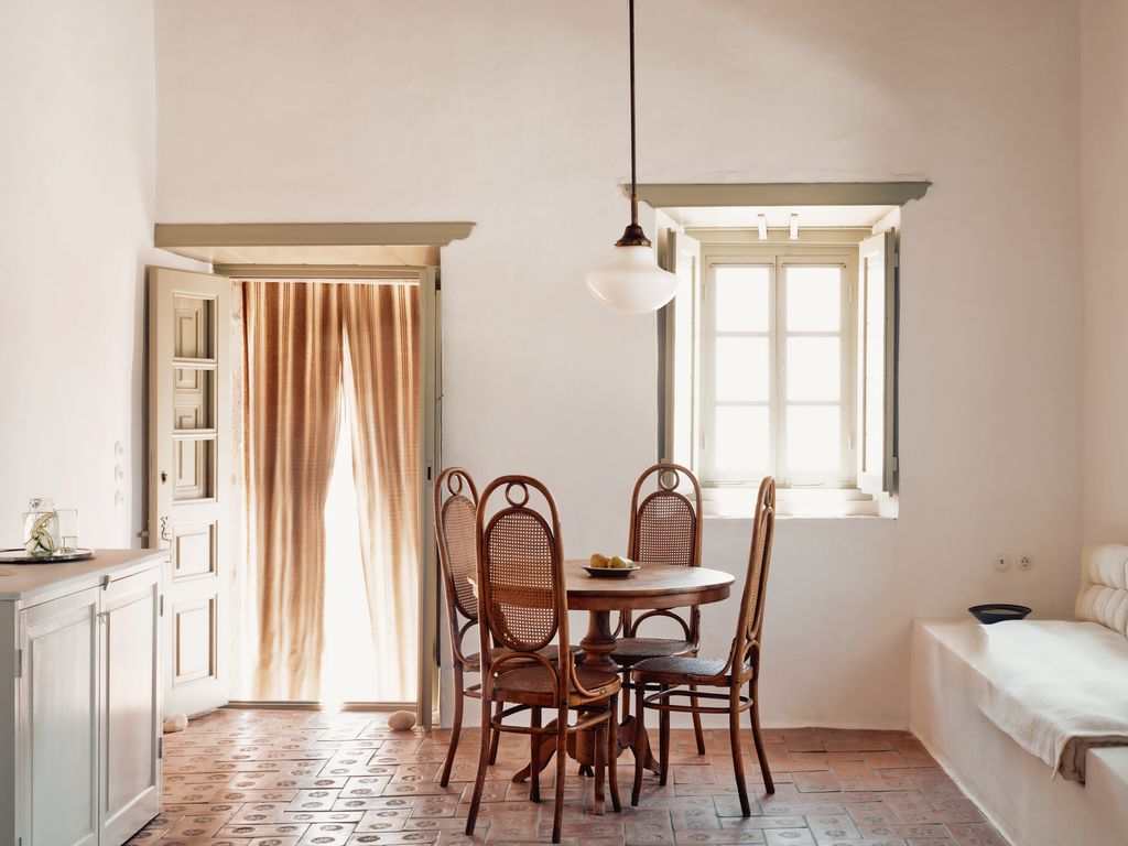 Antique bentwood and cane chairs surround a table in the Fireplace Room.