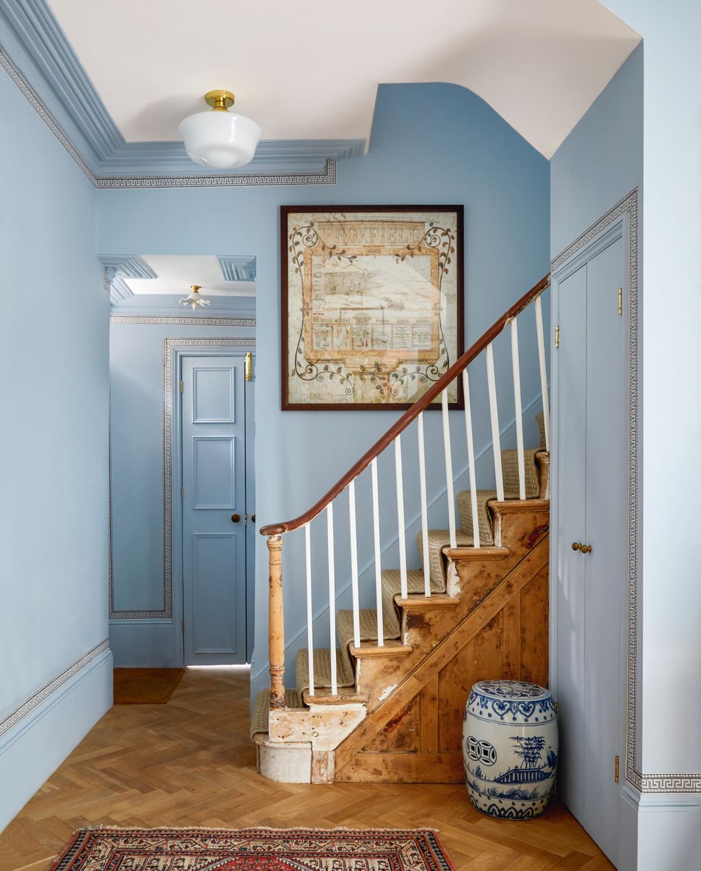 In this lovely hallway by Rachel Chudley the warm tones of the new walnut parquet flooring and restored staircase set...