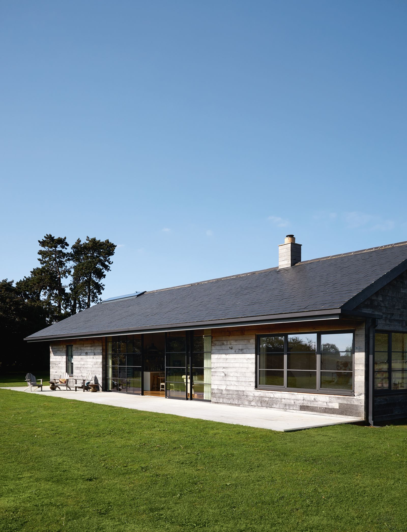 With its untreated oak cladding from Timberpride and slate roof the house was designed to blend with existing farm...