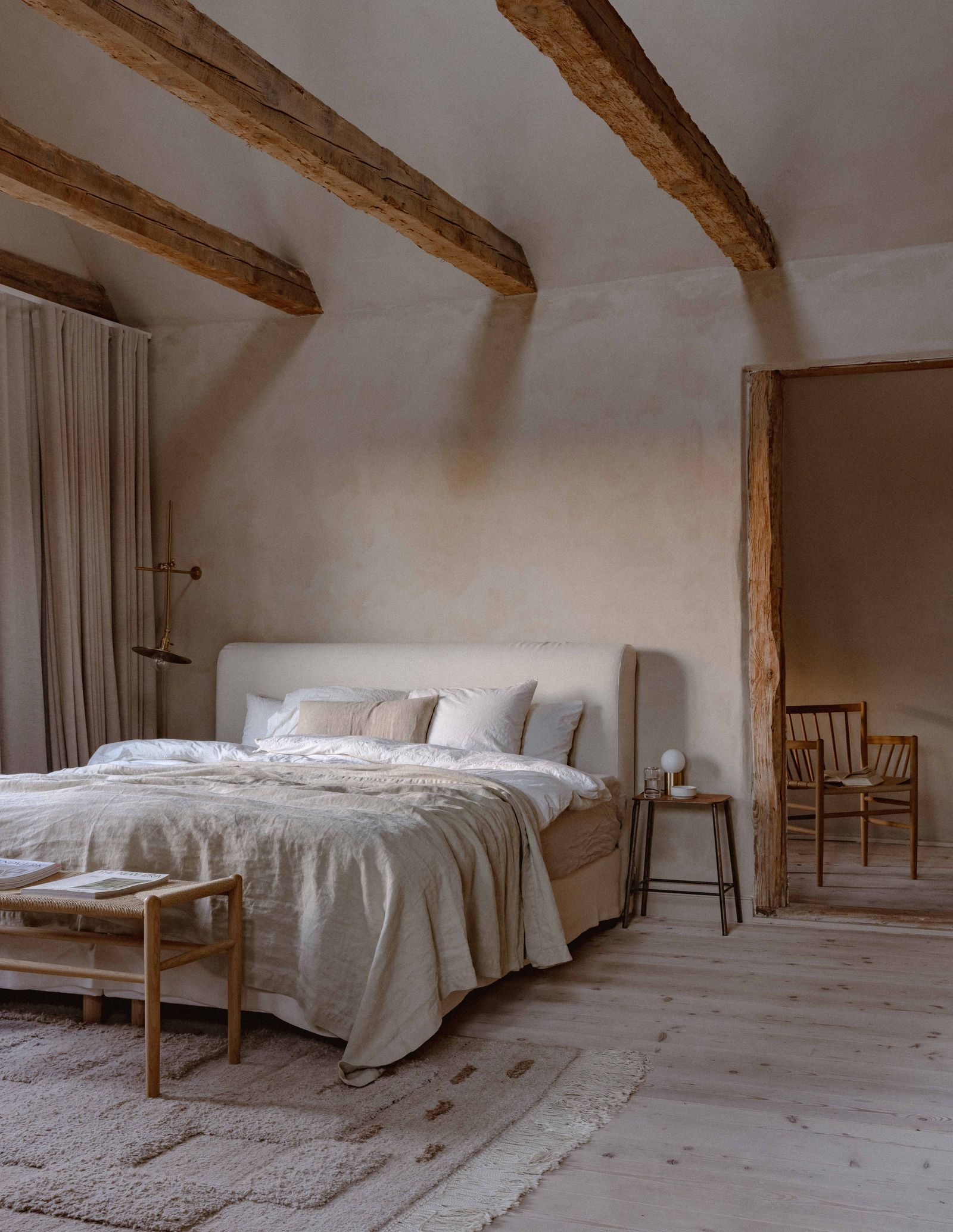 At the country house of the couple behind Our Food Stories the bed is covered with linens from By Mölle and Tekla