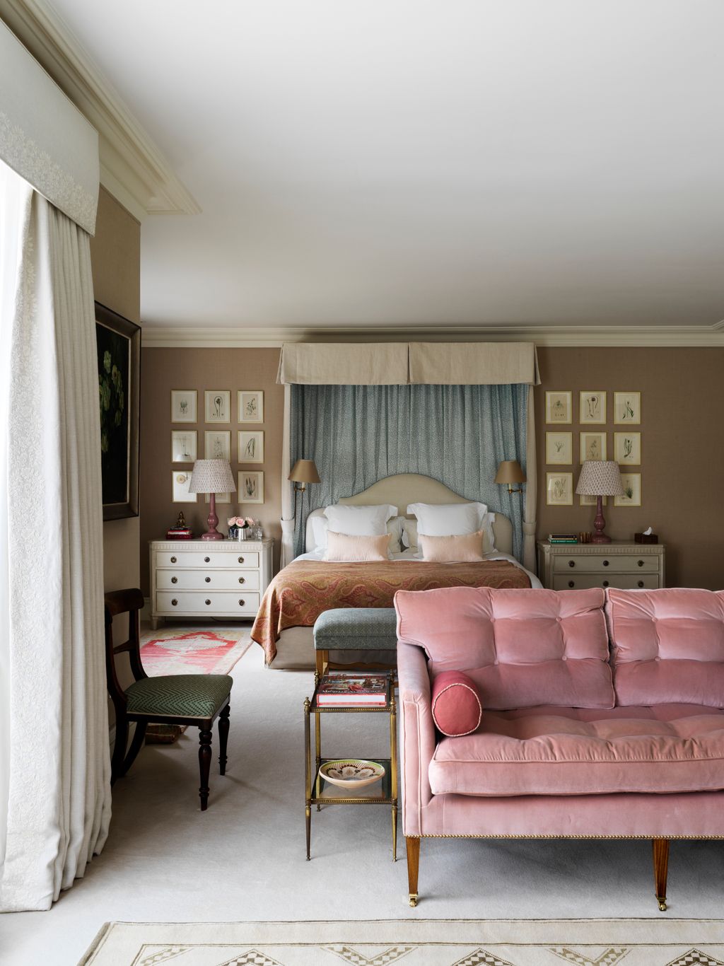 This room has been loosely divided into sleeping and sitting zones for a more relaxed feel. Fabric wall treatments and a...