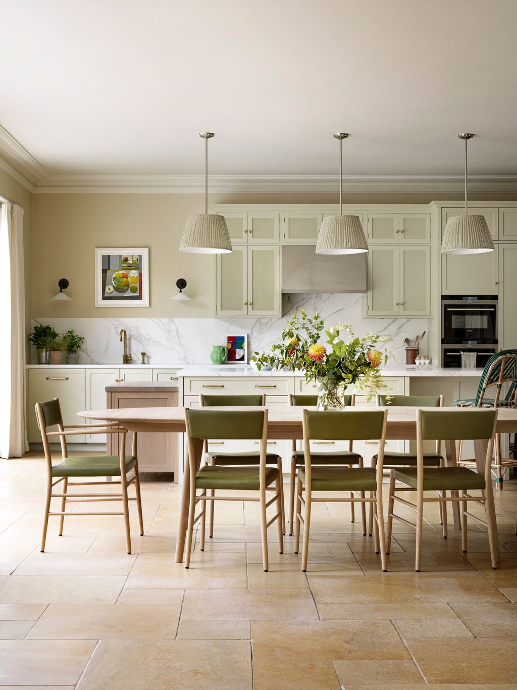 A large dining table and chairs from Pinch anchor this wide rear extension.