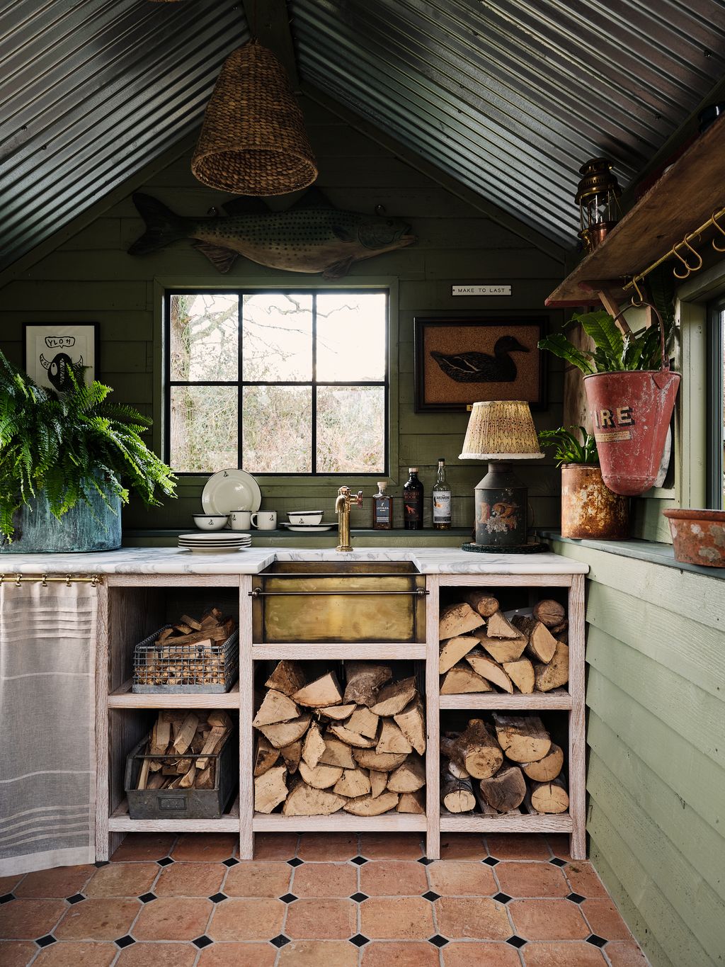 The interior of the kitchen with custom joinery a handmade burnished brass sink custom terracotta floor and decorative...