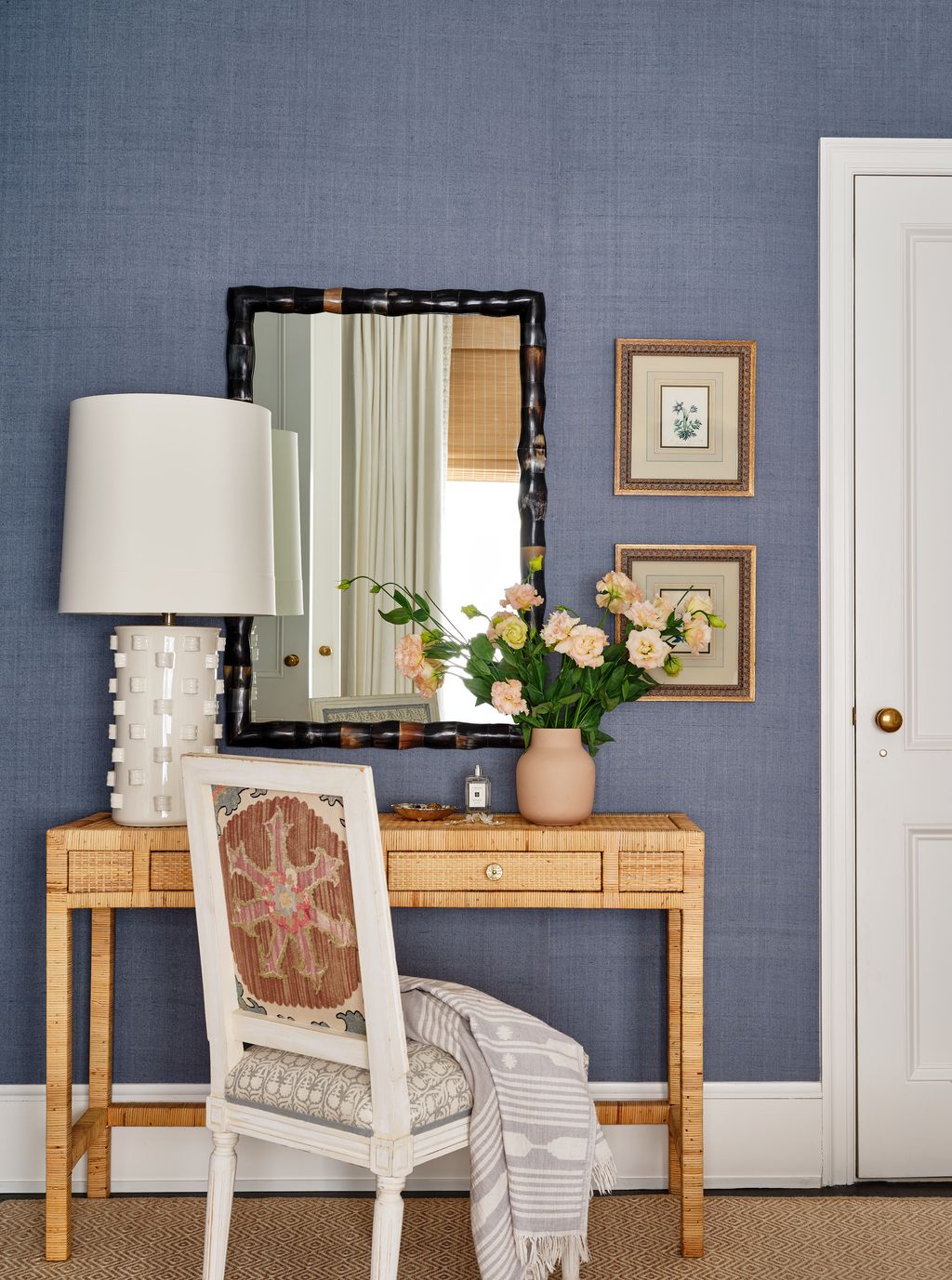 The makeup table is from Made Goods as is the mirror. The lamp comes from Arteriors and the chair is a vintage find.